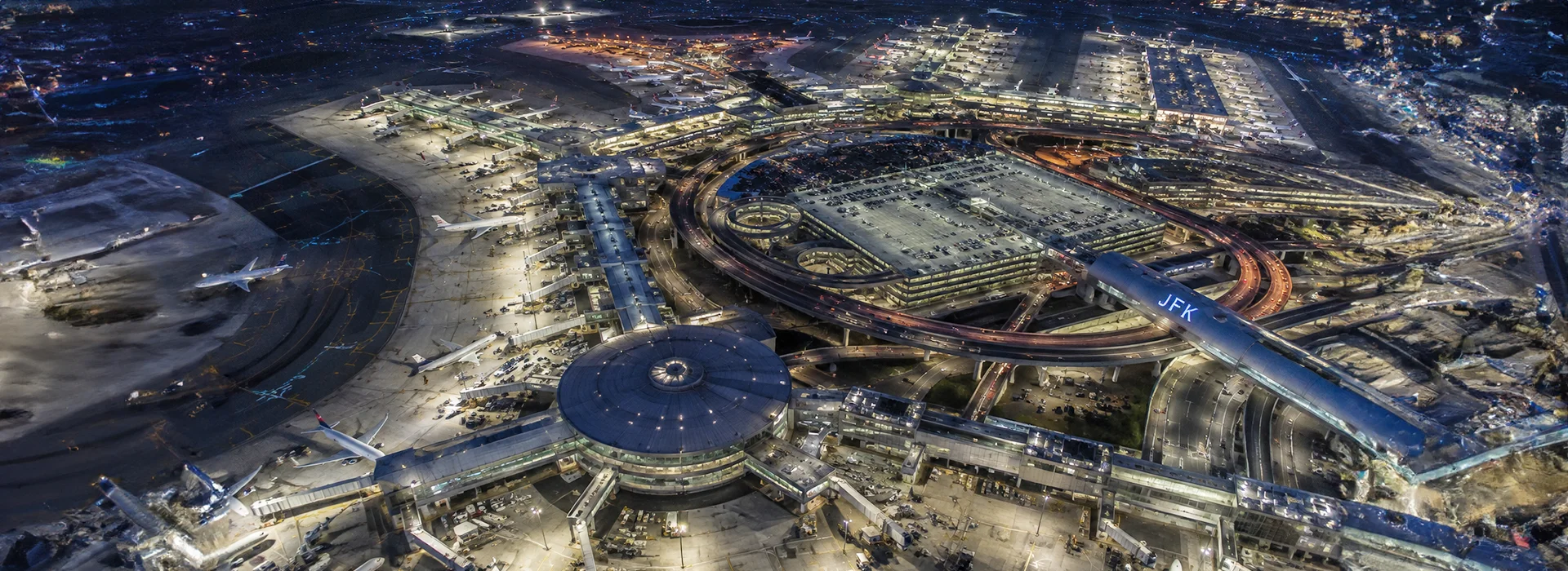 Aerial night view of JFK International Airport terminals in New York
