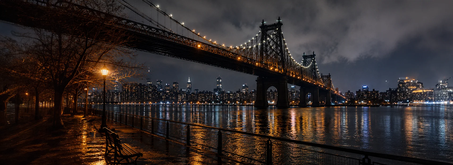 Queensboro Bridge over the East River at night with the Manhattan skyline