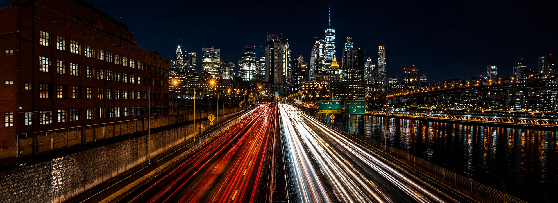 New York City highway at night with long light trails from moving traffic