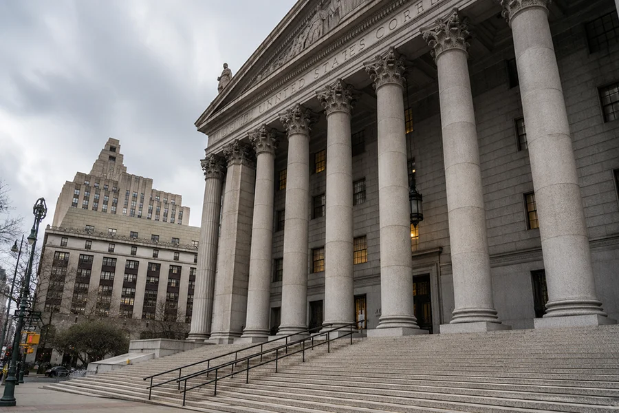 Stone columns and steps at the entrance of a New York City courthouse