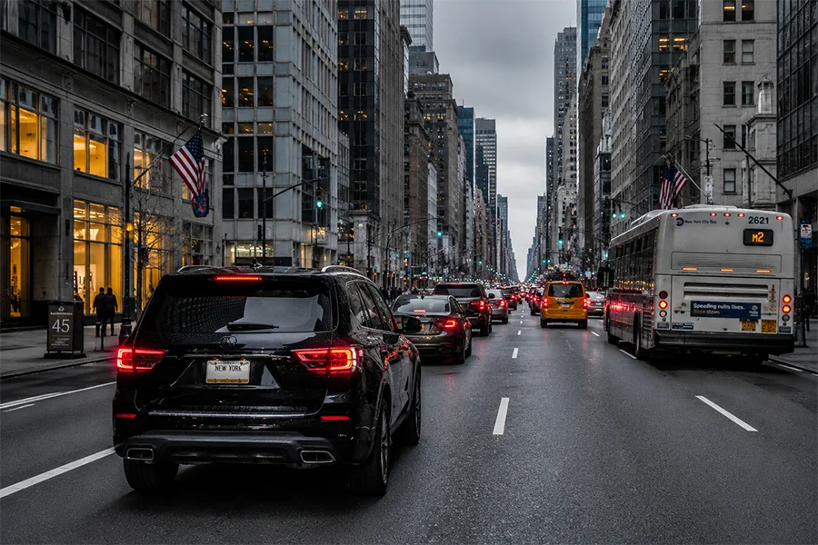 Black SUV following traffic on a New York City avenue during surveillance