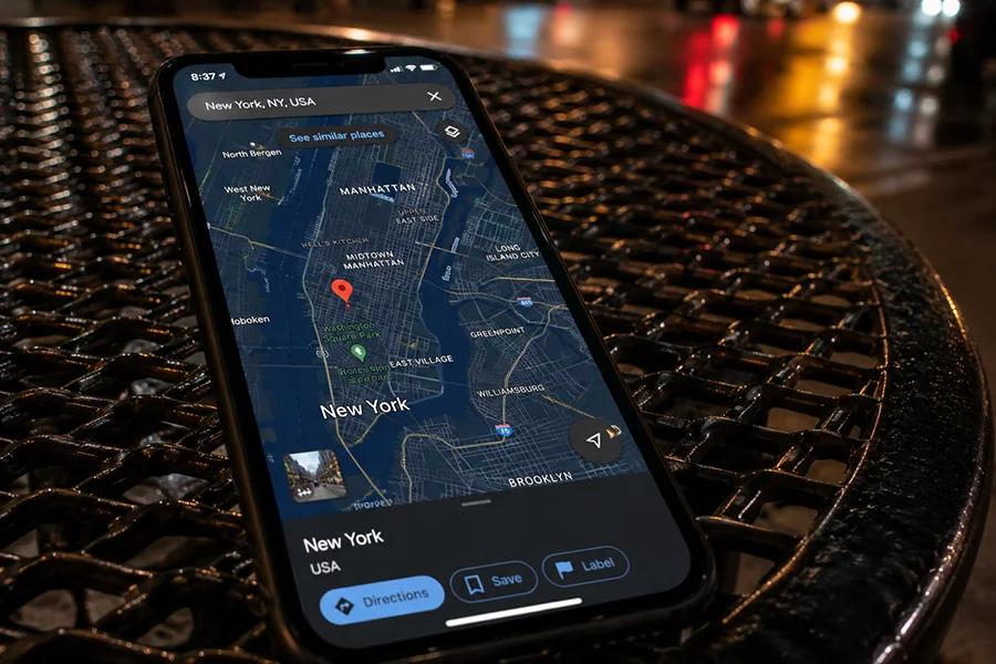 Smartphone showing a New York City map open on a table during a location search